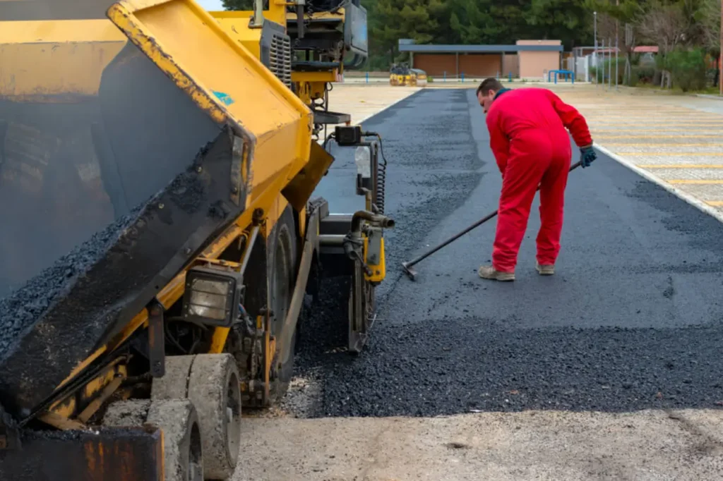 Trusted Asphalt Contractors Company Auckland operating paving machinery and leveling fresh asphalt for superior and even results.