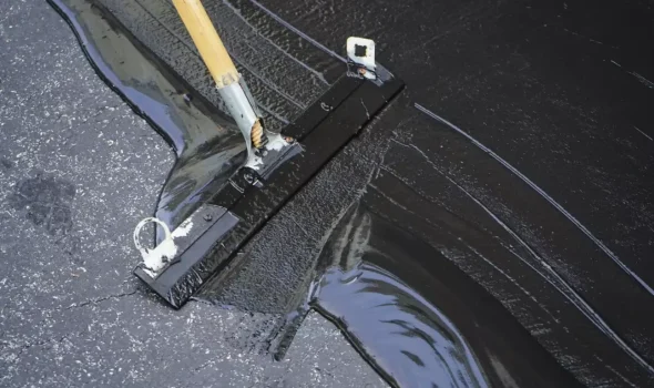 Cost Effective Tar Sealing by Asphalt Contractors Auckland Asphalt Contractors Auckland applying Tar Sealing with professional squeegee equipment for cost effective asphalt maintenance.